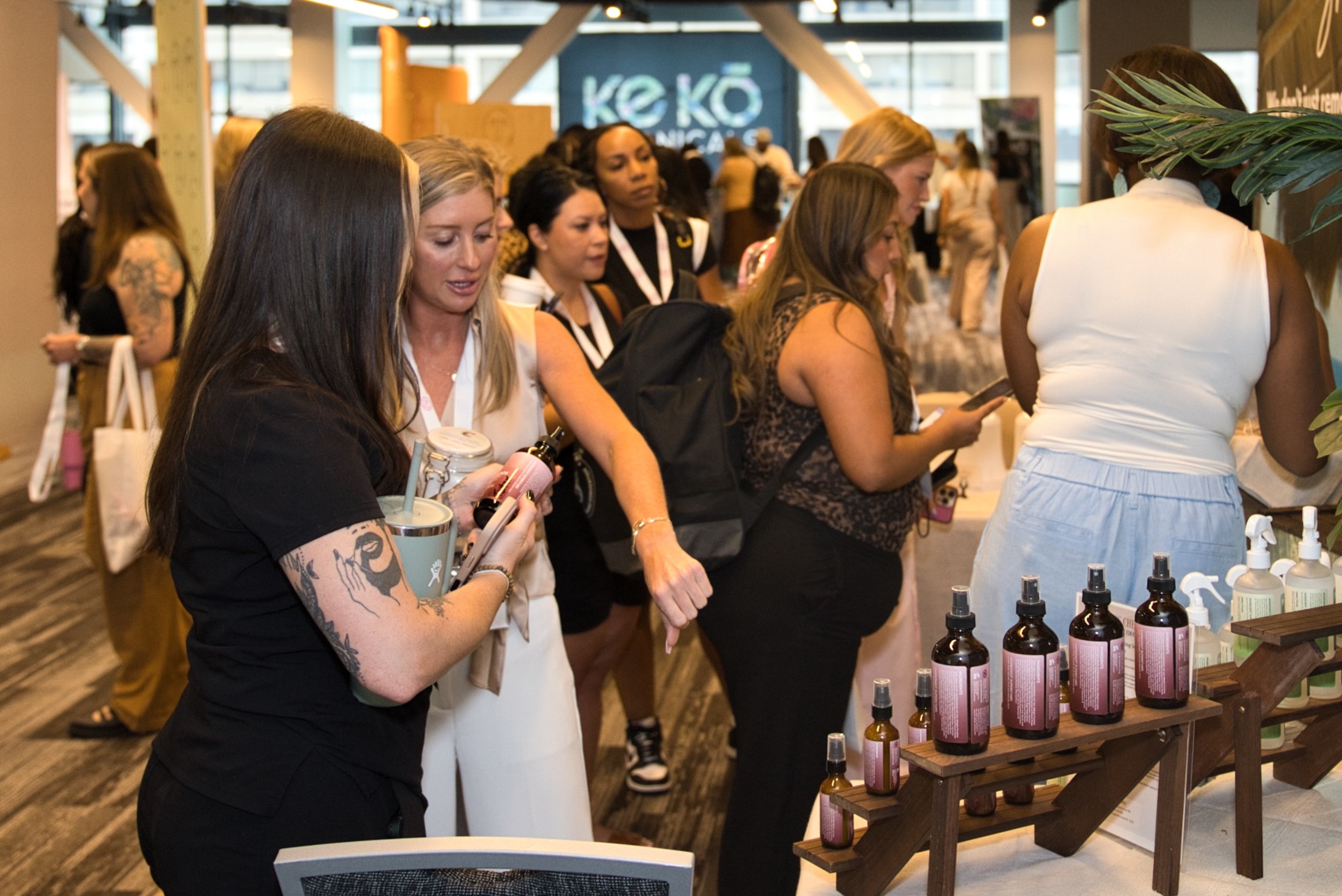 Sugar Con 2026 — attendees at a vendor booth on the exhibitor floor